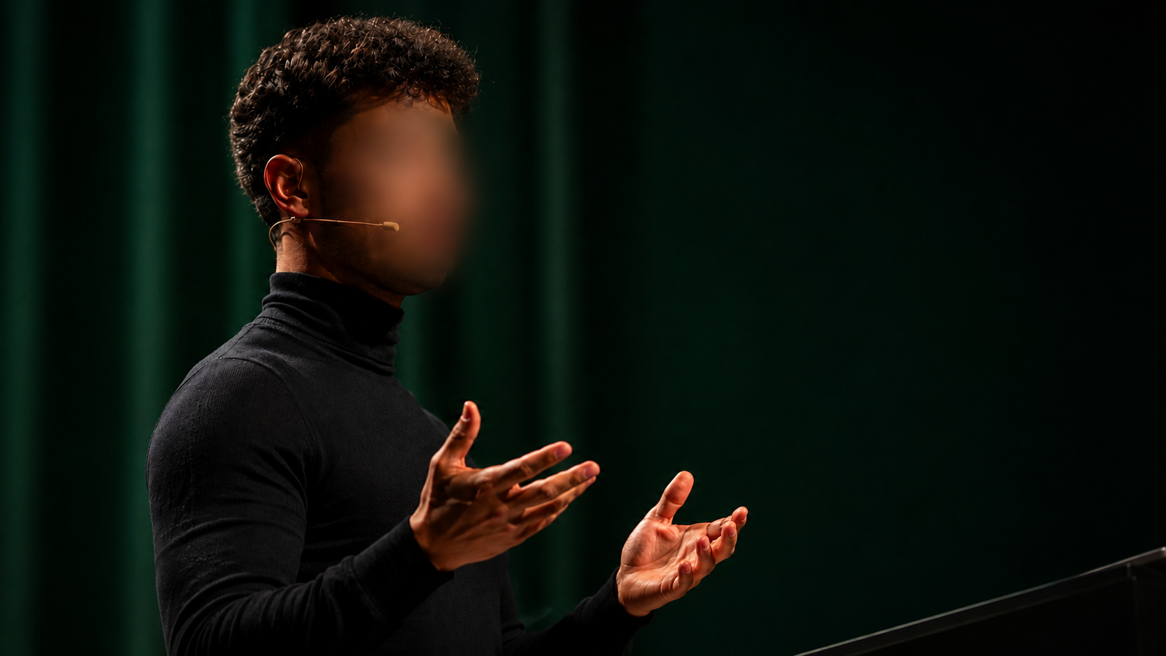 Presenter on stage with face hidden